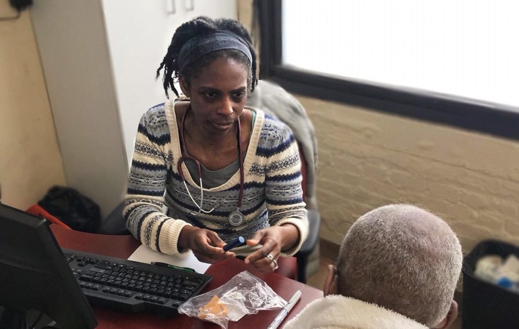 Care For the Homeless Physician Dr. Andrea Littleton with a Patient. Compassion.