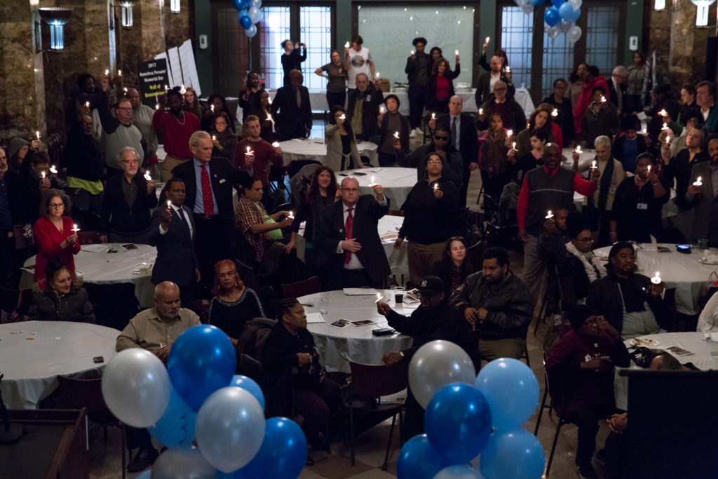 Audience at Homeless Persons' Memorial Day Raising Candles