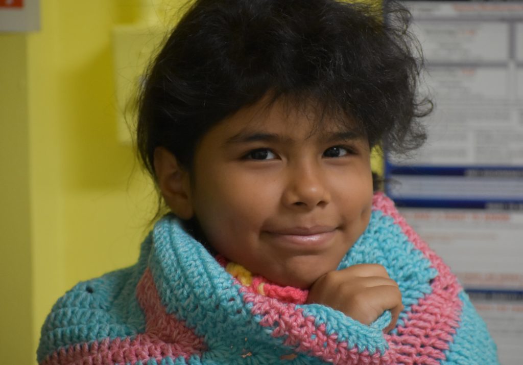 Young Patient with a Blanket. Make a donation.