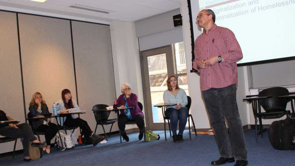 Philip speaking with college students